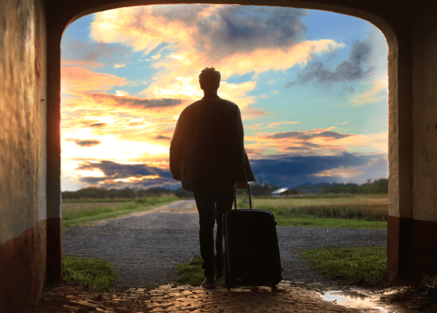 Beginner's Guide to Solo Travel - A man with a suitcase going out for solo travel
