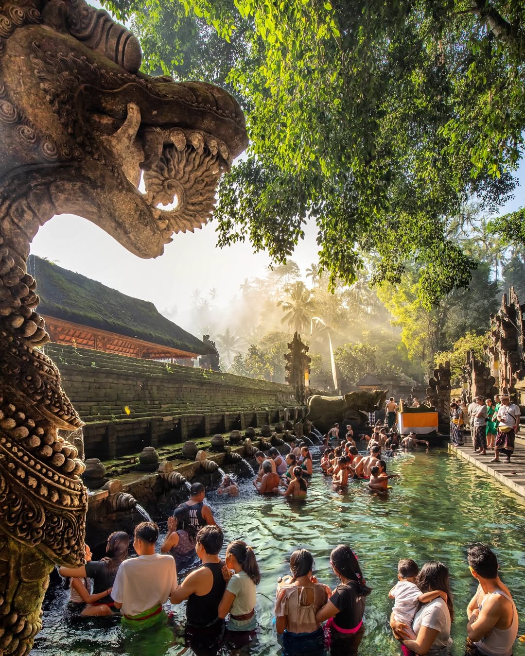 People doing melukat, a cleansing ritual at Pura Tirta Empul