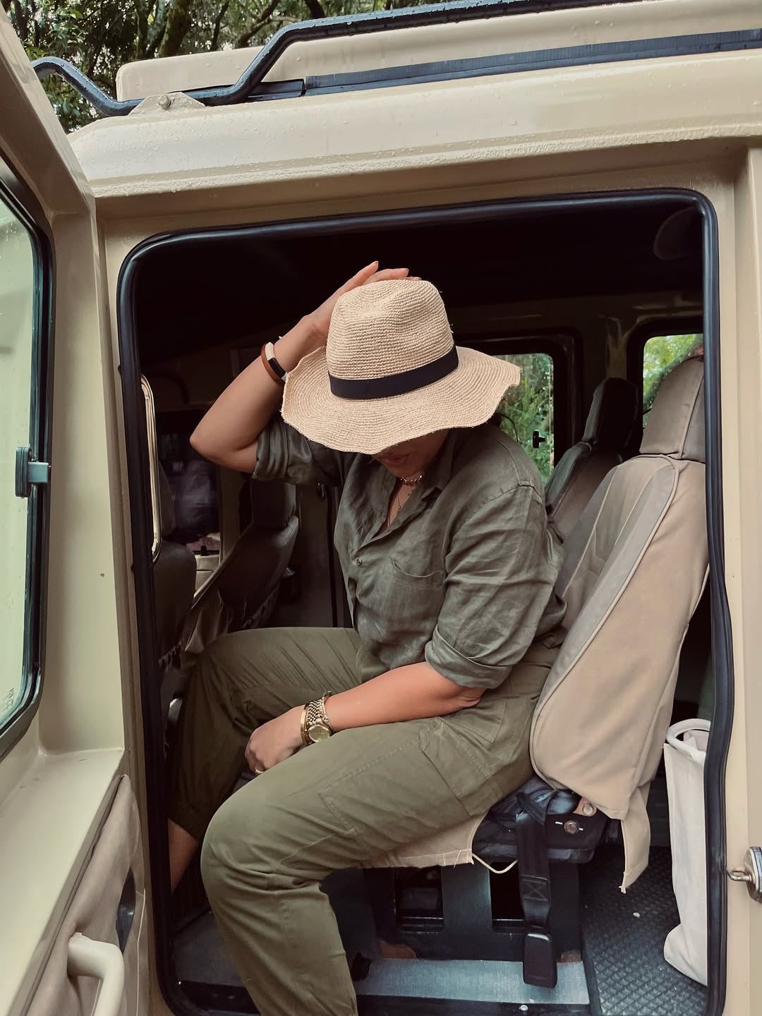 Fully clothed, olive color outfit with wide brimmed hat for sun protection