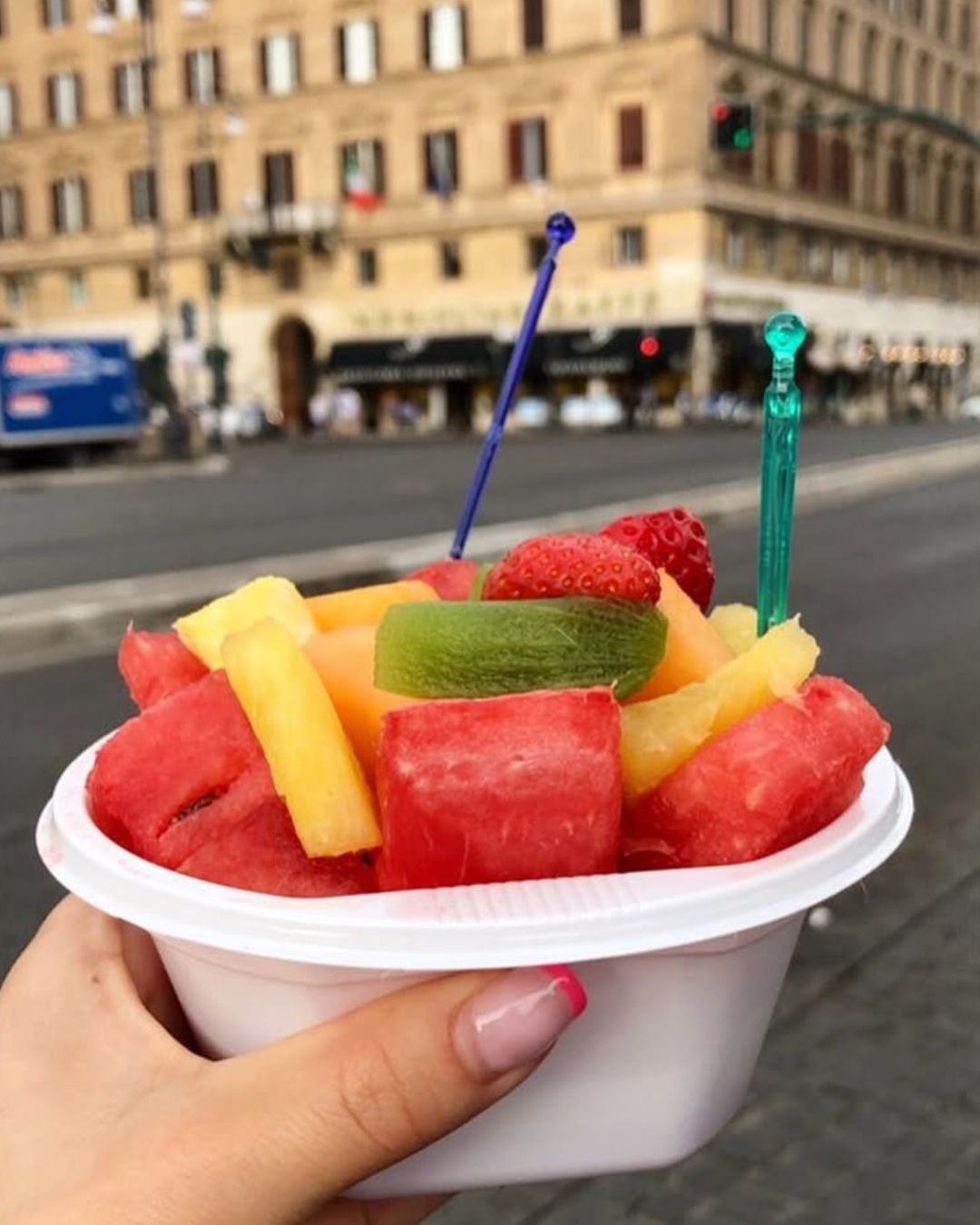 Eating fresh seasonal fruits on the streets of Rome